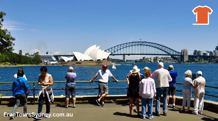Sydney City tour bus stopped at Mrs Macquaries Point. Tourists are enjoying the best views of both the Sydney Opera House and Sydney Harbour Bridge.